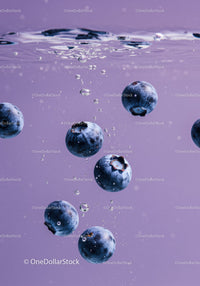 Fresh blueberries submerged in clear water bubbles