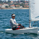 Man Sailing a Small Yacht in Blue Ocean Water