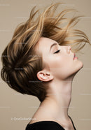 Serene woman with flowing hair against neutral background
