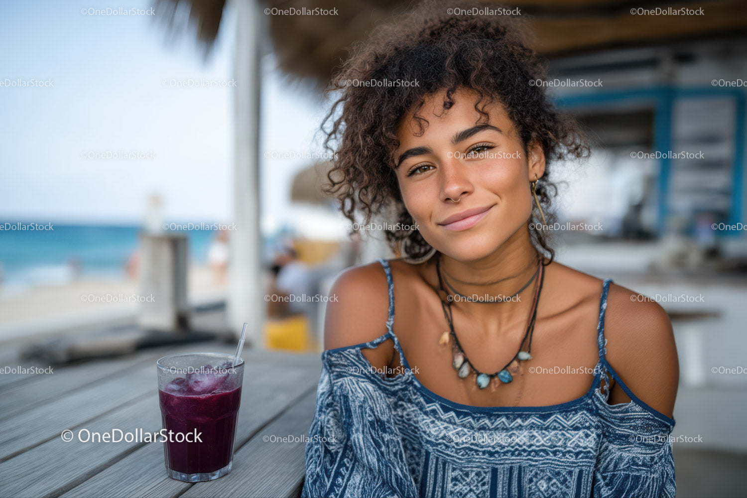 Young Woman with Curly Hair Smiling at Beachside Cafe