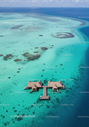 Overwater Bungalows Over Clear Turquoise Ocean with Coral Reefs