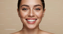 Close up of smiling woman with natural freckles and clear skin