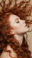 Profile of serene woman with flowing red curly hair
