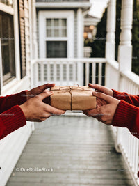 Exchanging a Carefully Wrapped Gift on Cozy Front Porch