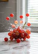 Fresh red grapes bursting with dynamic water splash