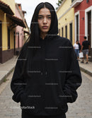 Fashionable Woman Wearing Black Hoodie in Urban City Street