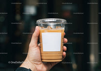 Hand Holding Plastic Cup of Iced Coffee with Milk