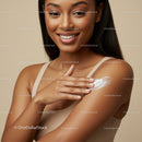 Young Woman Smiling Applying Lotion to Shoulder in Skincare Routine