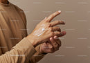 Close-up of a hand with skin moisturizer and white background