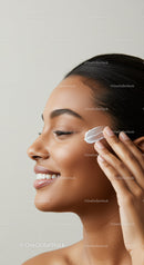 Woman Applying Facial Moisturizer with Skincare Routine
