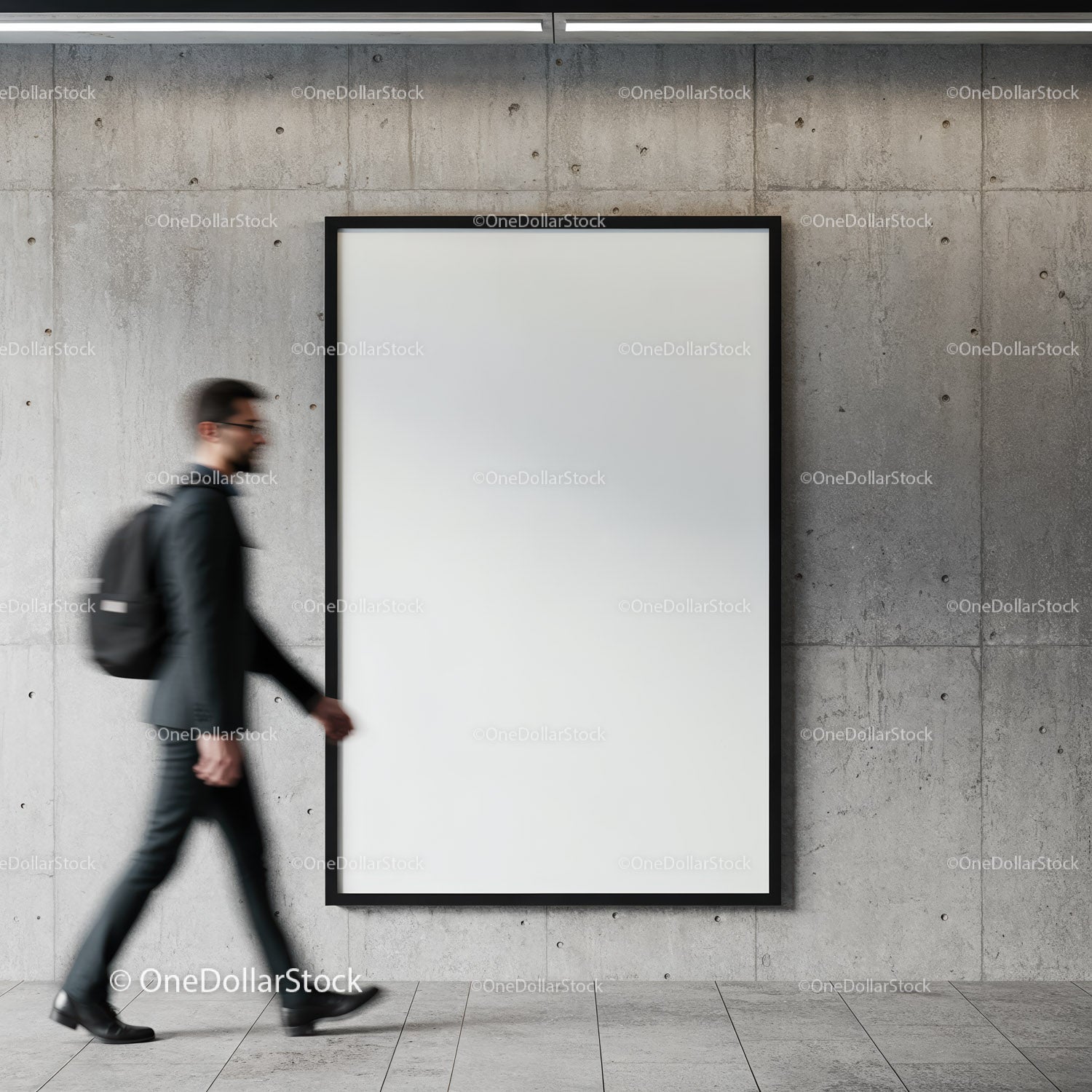 Businessman walking past blank framed poster on concrete wall