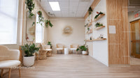 Bright and Cozy Indoor Waiting Room with Green Plants and Wooden Decor