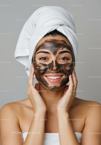 Young Woman with Black Facial Mask Applying Skincare Routine