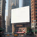 Blank billboard in urban street with yellow cabs