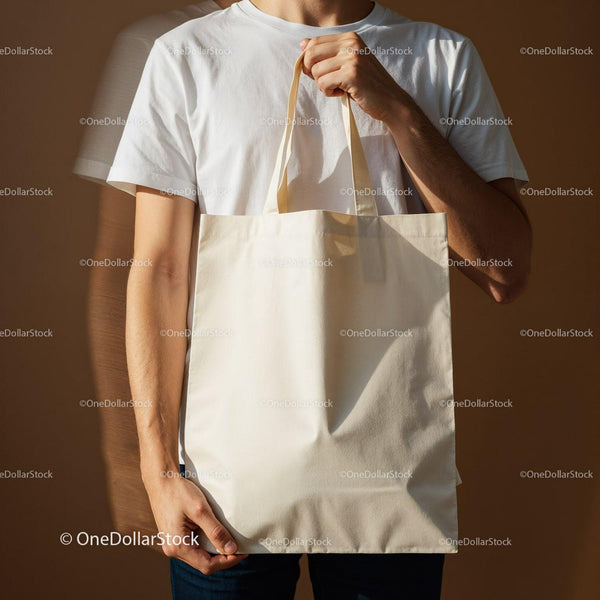 Man holding blank eco friendly canvas tote bag JPG Mockup Image