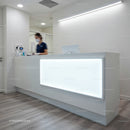 Modern medical reception area with nurse at counter