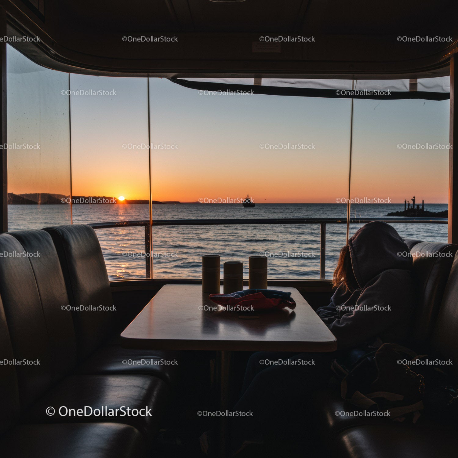 Sunset View from Ferry Interior Over Ocean Horizon with Watercraft