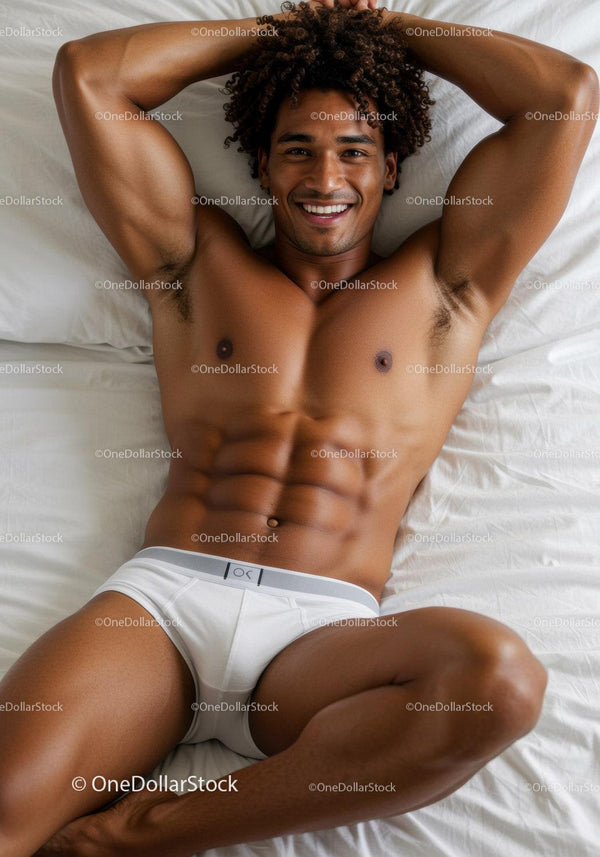 Smiling muscular man relaxing comfortably on bed