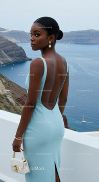 Elegant woman in light blue dress overlooking sea view