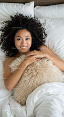 Smiling woman relaxing in bed with cozy fluffy pillow