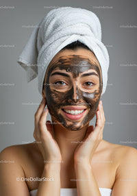 Young Woman with Facial Mask Applying Skincare Treatment