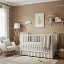Modern Nursery with White Baby Crib and Cozy Decor in Light Tones