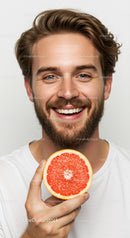 Smile of a Happy Bearded Man Holding a Juicy Grapefruit