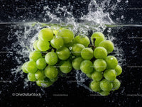 Fresh Green Grapes Splashing into Water with Bubbles