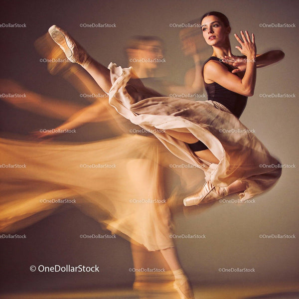 Graceful ballet dancer captured mid-air with flowing skirt