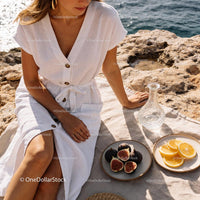 Woman Enjoying Fresh Figs and Oranges by the Sea