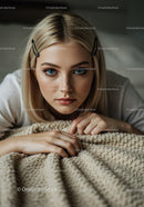 Portrait of Young Woman with Blue Eyes Relaxing on Beige Blanket