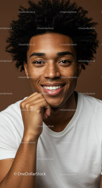 Close-up Portrait of Smiling Young Man with Curly Hair in Casual T-shirt