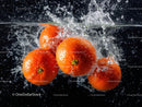 Juicy Oranges Splashing into Water Creating Freshness Effect