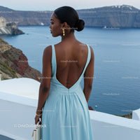 Elegant woman in blue dress overlooking ocean view