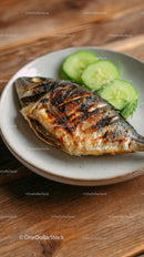 Grilled Fish with Cucumber Slices on Rustic Plate for Healthy Seafood Meal
