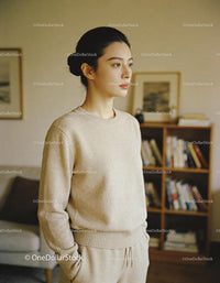Calm young woman standing thoughtfully at home