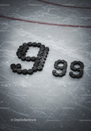 Hockey Pucks Arranged as Number 999 on Ice Rink