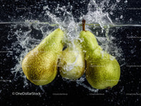 Fresh Green Pears Splashing into Water with Dynamic Motion