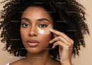Woman with Curly Hair Applying Under-Eye Gel Mask for Skincare