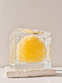 Fresh egg yolk frozen inside clear ice cube