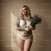 Tattooed Woman Holding Lavender Bouquet in Modern Indoor Portrait