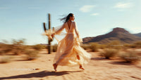 Carefree Woman in Flowing White Dress Dancing in Desert Landscape
