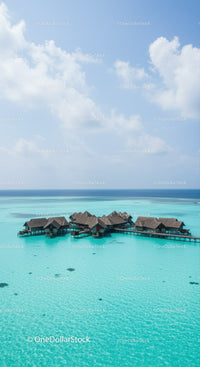 Beautiful Overwater Bungalows in Turquoise Ocean with Clear Sky