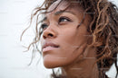 Close-up Portrait of a Woman with Wet Curly Hair and Water Droplets