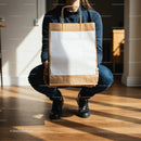 Person Holding Brown Paper Bag with Blank Label Indoors