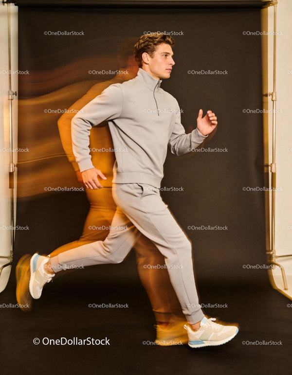 Young man jogging indoors in casual sportswear