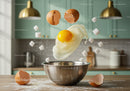 Fresh Egg Cracking Into Stainless Steel Bowl in Kitchen