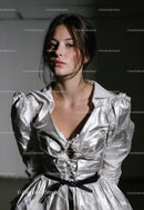 Young Woman Wearing Crinkled Silver Dress in Elegant Fashion
