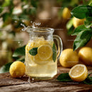 Fresh Lemonade with Sliced Lemons in a Glass Pitcher on Rustic Wooden Surface