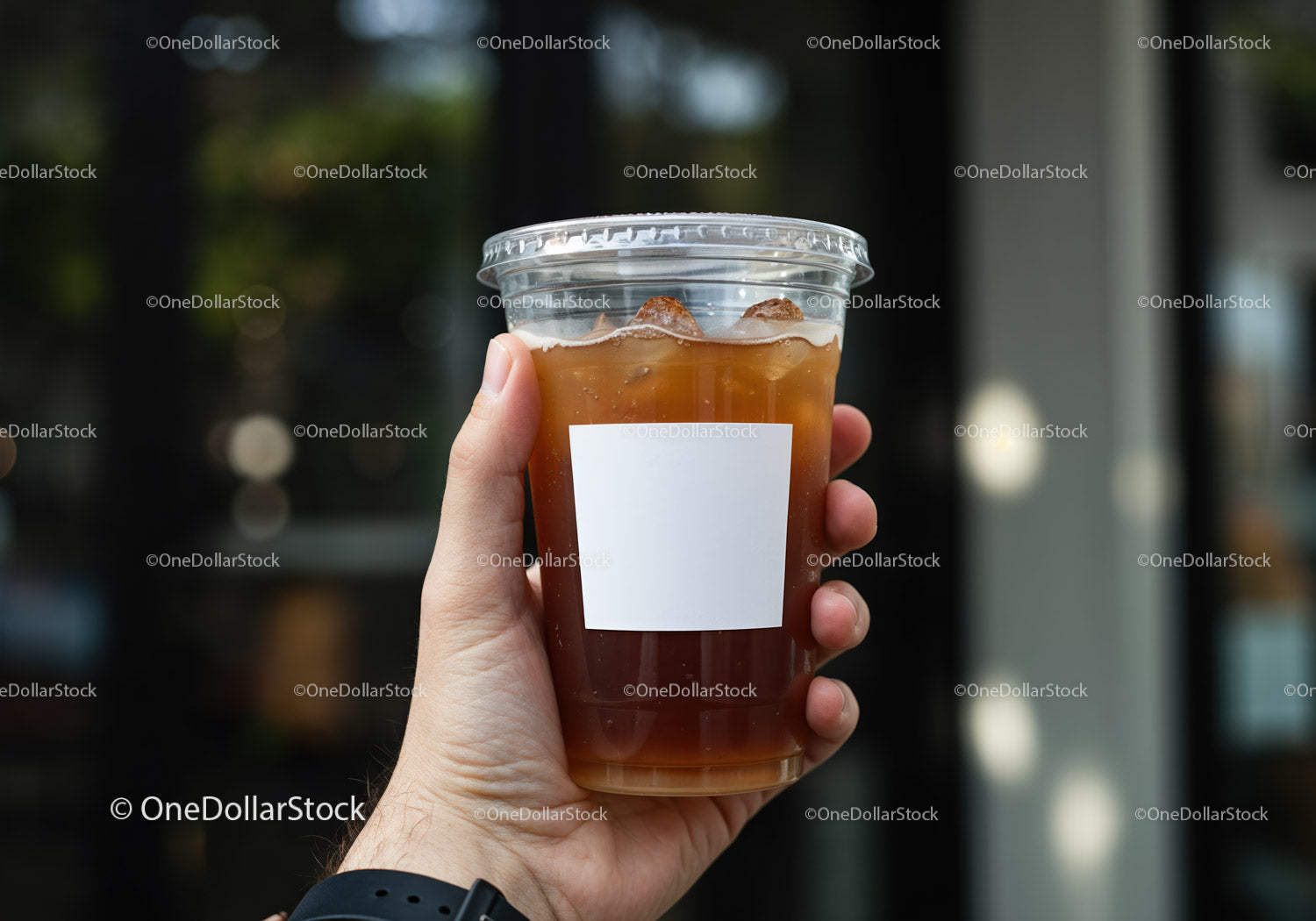 Hand Holding Iced Coffee in Clear Plastic Cup